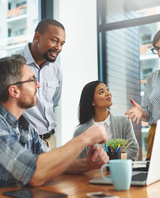 Teamwork, laptop and idea with business people in meeting for project management, review or planning. Technology, website and training with group of employees in office for collaboration and coaching.
